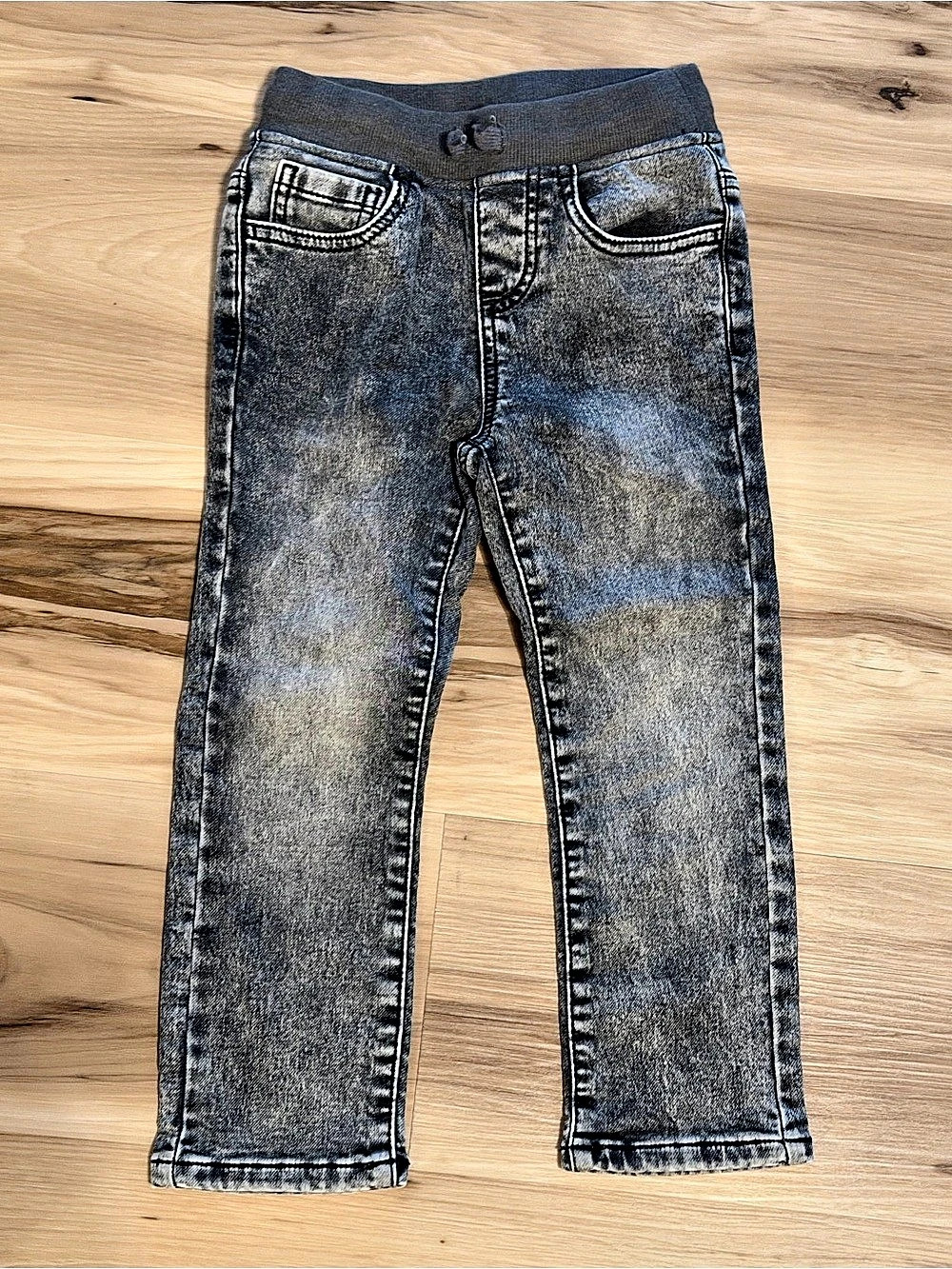 Acid washed black denim jeans with elastic waistband